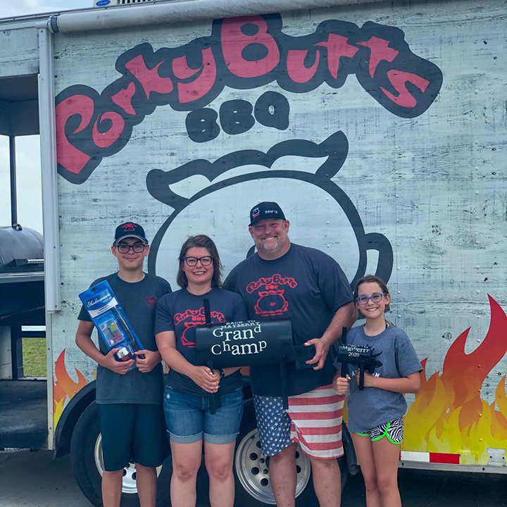 about-porky-butts-bbq-2 blane and his family accepting a grand champ bbq award